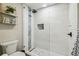 Bathroom featuring a glass-enclosed shower with white tile and decorative shelves at 4368 Marine Pkwy, New Port Richey, FL 34652