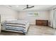 Bedroom featuring wood-look floors, modern ceiling fan, and plenty of natural light at 4368 Marine Pkwy, New Port Richey, FL 34652