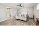 Bedroom with wood-look floors and convenient access to a connected bathroom and closet at 4368 Marine Pkwy, New Port Richey, FL 34652