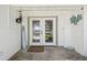 Inviting front entrance featuring double glass doors and charming nautical decor at 4368 Marine Pkwy, New Port Richey, FL 34652