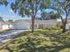 Charming single-story home featuring a white exterior, well-manicured lawn, and a spacious two-car garage at 4368 Marine Pkwy, New Port Richey, FL 34652