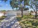 Charming single-story home featuring a white exterior, well-manicured lawn, and a spacious two-car garage at 4368 Marine Pkwy, New Port Richey, FL 34652