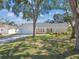 Charming single-story home featuring a white exterior, well-manicured lawn, and a spacious two-car garage at 4368 Marine Pkwy, New Port Richey, FL 34652