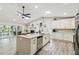 Spacious kitchen featuring a center island, stainless appliances, and a view of the outdoor patio at 4368 Marine Pkwy, New Port Richey, FL 34652