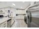 Well-lit kitchen boasting white cabinetry, stainless steel appliances, and a large island at 4368 Marine Pkwy, New Port Richey, FL 34652