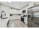Bright kitchen featuring stainless steel appliances, white cabinets, and a sleek black faucet at 4368 Marine Pkwy, New Port Richey, FL 34652