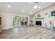 Spacious living room featuring a stone fireplace, wood flooring, and sliding glass doors to an outdoor space at 4368 Marine Pkwy, New Port Richey, FL 34652