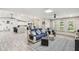 Bright living room in an open floor plan offering seamless access to kitchen and featuring coastal decor at 4368 Marine Pkwy, New Port Richey, FL 34652