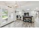 Bright living room with wood floors, nautical decor, and access to the front entrance at 4368 Marine Pkwy, New Port Richey, FL 34652