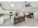 Spacious living area flowing from the kitchen, featuring a ceiling fan and wood-style flooring at 4368 Marine Pkwy, New Port Richey, FL 34652