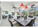 Covered patio with ceiling fans, comfortable seating, and views of the lush backyard and canal at 4368 Marine Pkwy, New Port Richey, FL 34652