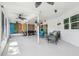 Screened lanai with multiple seating areas, string lights, and views of the backyard and canal at 4368 Marine Pkwy, New Port Richey, FL 34652