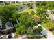 Aerial view of home showing lush landscaping, mature trees, and proximity to a pond at 4520 Wescott Ln, Tampa, FL 33624