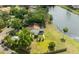 Aerial view of home's backyard featuring a pond, fenced yard, and screened-in porch at 4520 Wescott Ln, Tampa, FL 33624