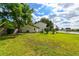 Green backyard with a view of the lake at 4520 Wescott Ln, Tampa, FL 33624