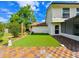 Outdoor space features synthetic grass and a patterned patio at 4520 Wescott Ln, Tampa, FL 33624