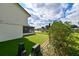 Landscaped backyard featuring a screened-in porch and artificial grass at 4520 Wescott Ln, Tampa, FL 33624