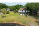 Aerial view of a home's backyard overlooking a pond with mature trees and a screened-in porch at 4520 Wescott Ln, Tampa, FL 33624