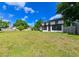Well-kept backyard with mature trees and partial fence at 4520 Wescott Ln, Tampa, FL 33624