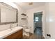 Bright bathroom featuring a modern vanity with sleek fixtures and open shelving for stylish storage at 4520 Wescott Ln, Tampa, FL 33624