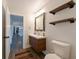 Bright bathroom featuring a modern vanity with sleek fixtures and open shelving for stylish storage at 4520 Wescott Ln, Tampa, FL 33624