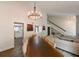 Open-concept dining and living area with a long wooden table and staircase to the second floor at 4520 Wescott Ln, Tampa, FL 33624