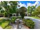 Beautiful single-Gathering home featuring lush landscaping, a driveway, and a serene atmosphere with a well-manicured lawn at 4520 Wescott Ln, Tampa, FL 33624