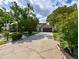 Charming single-Gathering home features a driveway, well-manicured lawn, and mature trees, creating a serene atmosphere at 4520 Wescott Ln, Tampa, FL 33624