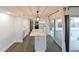 Stylish kitchen with a central island, white cabinets, stainless steel appliances and lots of light at 4520 Wescott Ln, Tampa, FL 33624