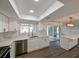 Bright kitchen featuring white cabinets, stainless steel appliances, and a kitchen island at 4520 Wescott Ln, Tampa, FL 33624