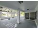 Enclosed lanai with ceiling fans and views of the lake at 4520 Wescott Ln, Tampa, FL 33624