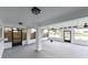 Enclosed lanai with ceiling fans and access to fenced yard at 4520 Wescott Ln, Tampa, FL 33624