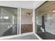 Living room with hardwood floors, a ceiling fan, and sliding door access to the lanai at 4520 Wescott Ln, Tampa, FL 33624