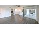 Spacious living room with hardwood floors adjacent to an open kitchen and outdoor patio at 4520 Wescott Ln, Tampa, FL 33624