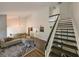 Bright living room boasting an open floor plan, vaulted ceilings, and staircase with black and white accents at 4520 Wescott Ln, Tampa, FL 33624