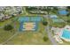 An aerial view of a community recreational area featuring tennis and basketball courts, pool, and playground at 4520 Wescott Ln, Tampa, FL 33624