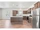 Open kitchen with wood flooring, stainless steel appliances, an island, and natural light at 4568 18Th S Ave, St Petersburg, FL 33711