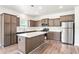 Bright kitchen with stainless steel appliances, wood flooring, an island, and ample cabinet space at 4568 18Th S Ave, St Petersburg, FL 33711