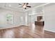 Open concept living room with wood flooring, a ceiling fan, and bright, natural light at 4568 18Th S Ave, St Petersburg, FL 33711