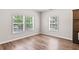 Room featuring wood flooring, neutral paint, three windows, and ample lighting at 4568 18Th S Ave, St Petersburg, FL 33711