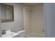 Bathroom featuring a single sink vanity, commode, and tiled shower and tub with shower curtain at 4724 Michael Ct # 122, Tampa, FL 33614