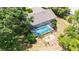 The roof over the house is visible in this aerial view, with a pool and mature trees at 5298 Florentine Ct, Spring Hill, FL 34608
