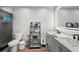 Bright bathroom featuring a double vanity with quartz countertops and a modern, lighted mirror at 5298 Florentine Ct, Spring Hill, FL 34608