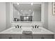 Close-up of a bright bathroom featuring a double vanity with quartz countertops and modern fixtures at 5298 Florentine Ct, Spring Hill, FL 34608