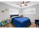 Cozy bedroom showcasing a blue-themed decor with a comfortable bed and ample natural light at 5298 Florentine Ct, Spring Hill, FL 34608