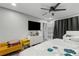 Modern bedroom with wood floors, a ceiling fan, ample lighting, and neutral-toned walls at 5298 Florentine Ct, Spring Hill, FL 34608