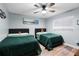 Shared bedroom showcasing two beds with green comforters and wall art, great for  at 5298 Florentine Ct, Spring Hill, FL 34608