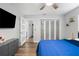 Bedroom featuring a large closet, a blue bed, and access to an attached bathroom at 5298 Florentine Ct, Spring Hill, FL 34608