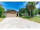 Charming single-story home with a stone accent wall and a spacious paved driveway at 5298 Florentine Ct, Spring Hill, FL 34608