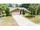 Charming single-story home featuring a stone accent, two-car garage, and a brick-paved driveway at 5298 Florentine Ct, Spring Hill, FL 34608